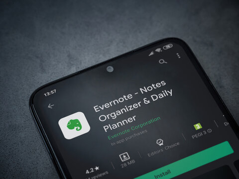Lod, Israel - July 8, 2020: Evernote app play store page on the display of a black mobile smartphone on dark marble stone background. Top view flat lay with copy space.