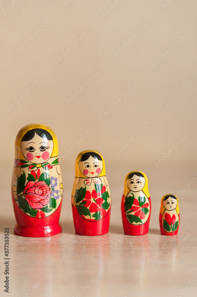 Wall mural Russian doll. matryoshka. four dolls stand on a beige background