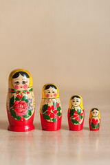 Russian doll. matryoshka. four dolls stand on a beige background