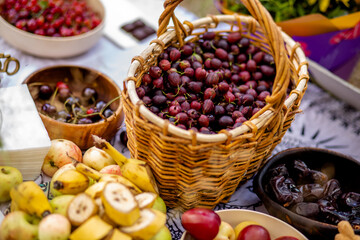 a basket of gooseberries and other fruits are on the table