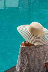 woman at spa resort by the swimming pool.