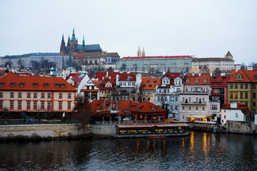 Fototapeta premium Scenic evening panorama of the Old Town architecture with Vltava river in Prague, Czech Republic