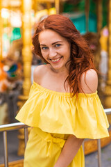 Happy beautiful redhead girl walking in the park