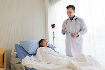 asian child girl patient getting blood transfusion in hospital