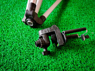 Broken mobile tripod isolated on green background.Side view