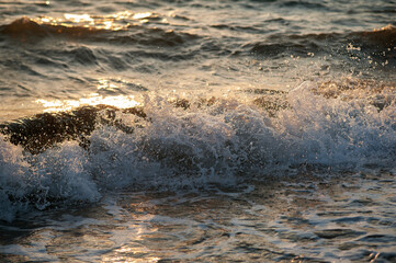 Splashing water in the rays of the setting sun.