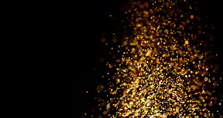 Gold glitter stardust trail on black background. Christmas golden spark border with space. Luxury...