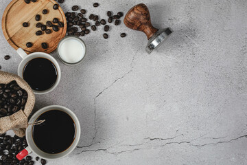 Fototapeta na wymiar A cup of coffee and coffee beans on white, marble background