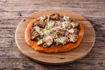 Autumn pumpkin pizza with vegetables on wooden table	