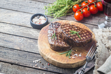 Grilled marbled meat steak Filet Mignon with seasonings. Juicy beef steak on cutting board.