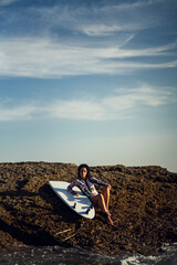 Fototapeta na wymiar Joven atractiva con tabla de surf practicando en cadiz