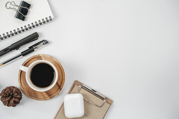 Flat lay, top view office table desk. Workspace with blank clip board, keyboard, office supplies, pencil and coffee cup on white background.