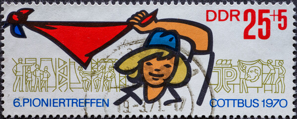 GERMANY, GDR - CIRCA 1970: a postage stamp from Germany, GDR showing a girl with pioneer scarves tied together Text: Pioniertreffen, Cottbus