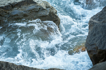 A piece of sea and stones, splashes, water, neutral background
