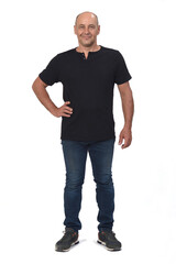 full portrait of a bald man on white background, hand on hip