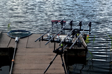 Carp fishing rods in the lake. Rods on a rod pod with the swingers attached ready to catch a fish