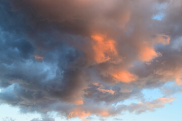 Sky background with clouds with reddish sunset tones