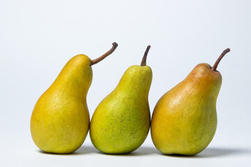 Pears on a white background. Three pears lie next to each other. Healthy fruits