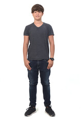 Naklejka premium portrait of a teenage boy on white background with hands in pockets