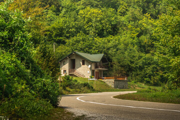 Fototapeta na wymiar Country road somewhere in the mountains of montenegro, hotel for travelers