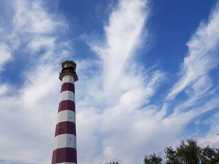 Lighthouse against the sky, painted in red and white