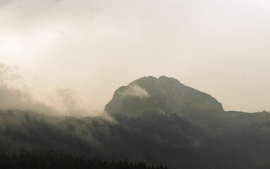 Fototapeta premium Very high mountain in the clouds, peak in the haze, montenegro, panorama