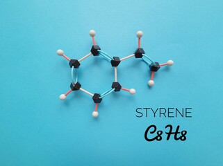 Molecular structure model and chemical formula of styrene molecule. Styrene is a flammable liquid...