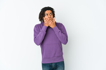 Young african american rasta man thoughtful looking to a copy space covering mouth with hand.