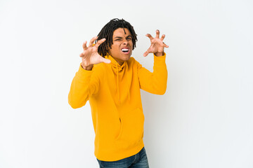 Young african american rasta man showing claws imitating a cat, aggressive gesture.