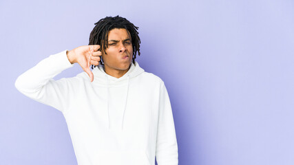 Young african american rasta man showing thumb down, disappointment concept.