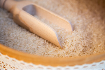 Traditional wedding custom with rice bowl and carved wooden spoon as a background
