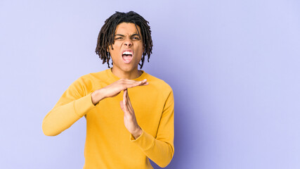 Young black man wearing rasta hairstyle showing a timeout gesture.
