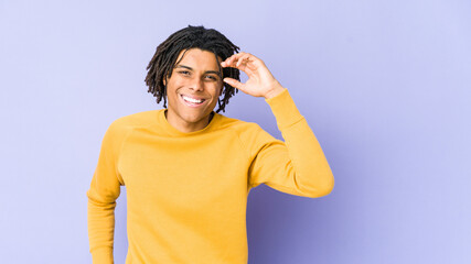 Young black man wearing rasta hairstyle joyful laughing a lot. Happiness concept.