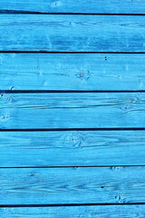 the wall is made of old horizontal boards painted in light blue. old wood texture, vintage style