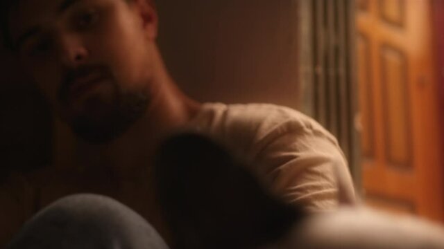 Handsome young man is lean against the wall and he love his dog. Cinematic look