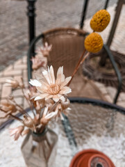 Fototapeta na wymiar Retro style wallpaper flowers on a table near restaurant 