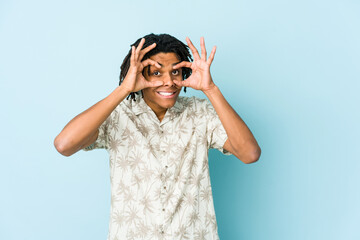 Young african american rasta man keeping eyes opened to find a success opportunity.