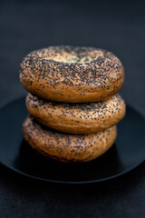Black plate full of Bagels on a Black Background