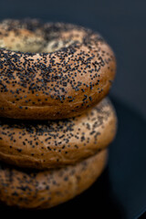Black plate full of Bagels on a Black Background