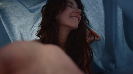 POV cheerful girl posing under folds fabric. Woman posing camera under sheets.