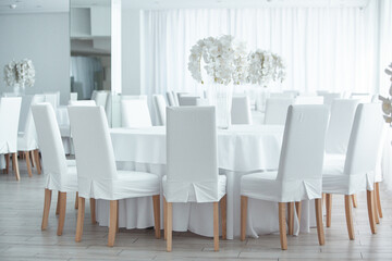 Empty restaurant luxury interior background. Empty chair and table inside room photo. White restaurant interior.
