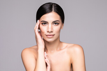 Beauty portrait of an attractive half naked woman looking at camera isolated over gray background