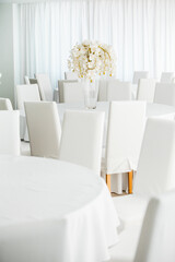 Empty restaurant luxury interior background. Empty chair and table inside room photo. White restaurant interior.