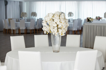 Empty restaurant luxury interior background. Empty chair and table inside room photo. White restaurant interior.