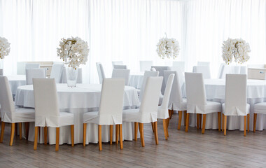 Empty restaurant luxury interior background. Empty chair and table inside room photo. White restaurant interior.