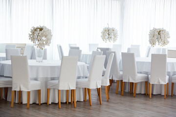 Empty restaurant luxury interior background. Empty chair and table inside room photo. White restaurant interior.