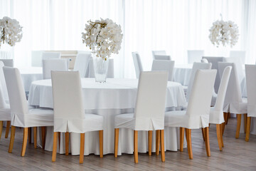Empty restaurant luxury interior background. Empty chair and table inside room photo. White restaurant interior.