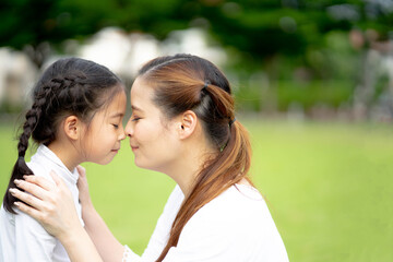 Happy loving family, Mom and daughter playing and kissing, Togetherness concept.