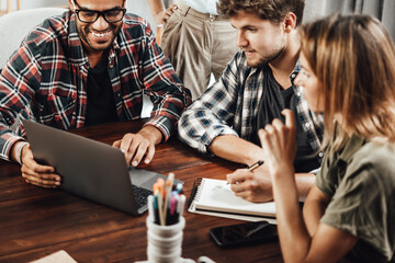 Group of young people working together. Creative business people in modern office. Hipster team in...