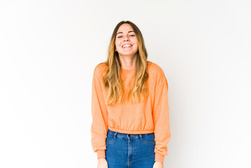 Fototapeta premium Young caucasian woman isolated on white background laughs and closes eyes, feels relaxed and happy.